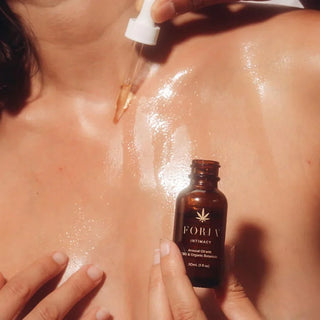 Female using oil on chest for moisturizing.