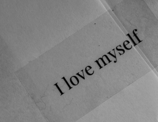 A close-up photo of a handwritten note that says "I love myself"
