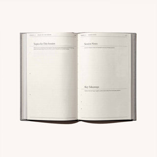 A book with an open page featuring a handwritten note.