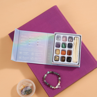 Assorted crystals and items in a box on a table.