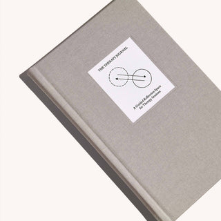 An open book featuring a white sticker on its cover.