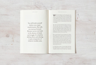 An open book displaying a quote on one of its pages, inviting readers to explore the wisdom within.