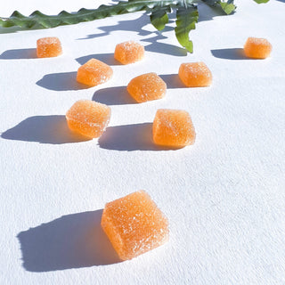 Orange gummy arranged on a white surface, creating a vibrant and playful display.