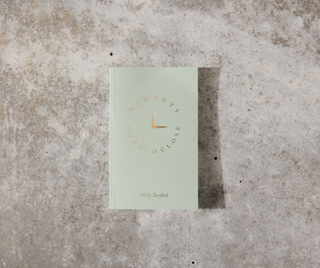 An assortment of wellness products from Adose Wellness, including books, stationery, and art for mindfulness and relaxation.