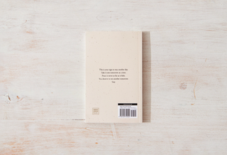 A book on a wooden surface featuring an inspiring quote.