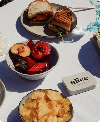 A white table cloth covering a table with alice mushroom chocolate