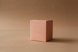 A pink box on a brown surface.