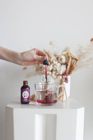 Filling a glass with liquid.