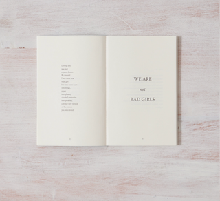A book cover with the words "We are not bad girls" written on it, conveying a message of empowerment and breaking stereotypes.