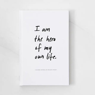 "Empowering quote 'I am the hero of my own life journal' on a colorful background."