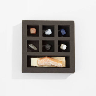 A box filled with stones and assorted items.