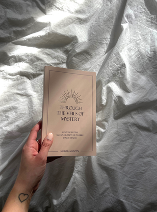 The sun's rays gently fall on the book cover, enhancing the colors and textures, creating a serene and captivating image.