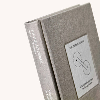Image of an open book with a white cover.
