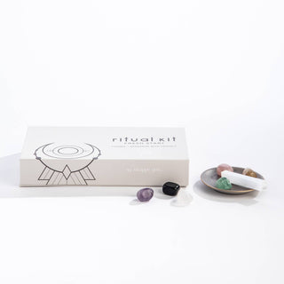 A box containing a crystal bowl, a crystal spoon, and a small bowl, all neatly arranged.