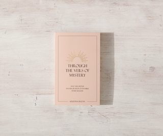 A book titled 'Through the Veils of Mystery' with words written on its cover, symbolizing the season's scorching temperatures.