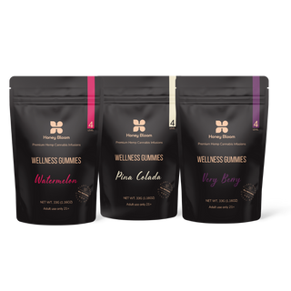 Black and white photo featuring three bags of Honey Bloom, showcasing various blends and origins.