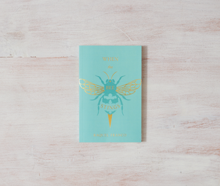 Blue notebook with gold bee design, perfect for nature lovers or bee enthusiasts.