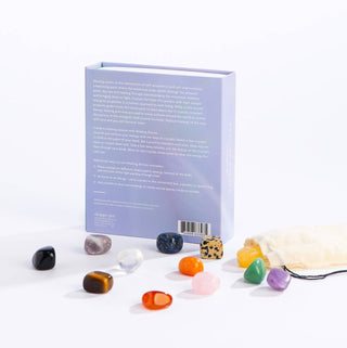 A collection of stones next to a book on a table.