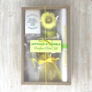 A gift box adorned with a yellow ribbon and a delicate yellow flower.