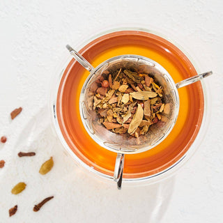  A cup of  Tulsi-Turmeric Herbal Tea with spices, perfect for a cozy afternoon break.