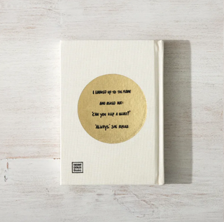 "I looked up at the moon," elegantly displayed in gold foil on the wooden surface.