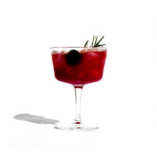 A vibrant red cocktail with a decorative garnish atop, adding a touch of elegance and flavor.