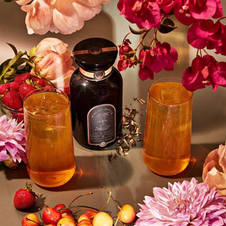 Tea glasses and flowers on a table.