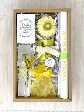 A gift box with yellow flowers and a note, perfect for special occasions.