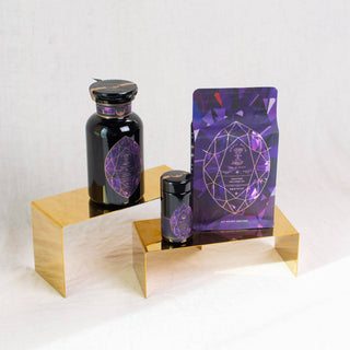 A bottle of purple and black liquid on a gold stand, showcasing an intriguing and elegant color combination.