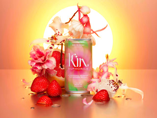 A can of Kin with strawberries and flowers, a refreshing and vibrant combination.