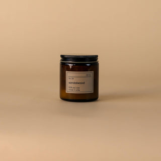 A jar of candles on a beige background, creating a warm and cozy ambiance.